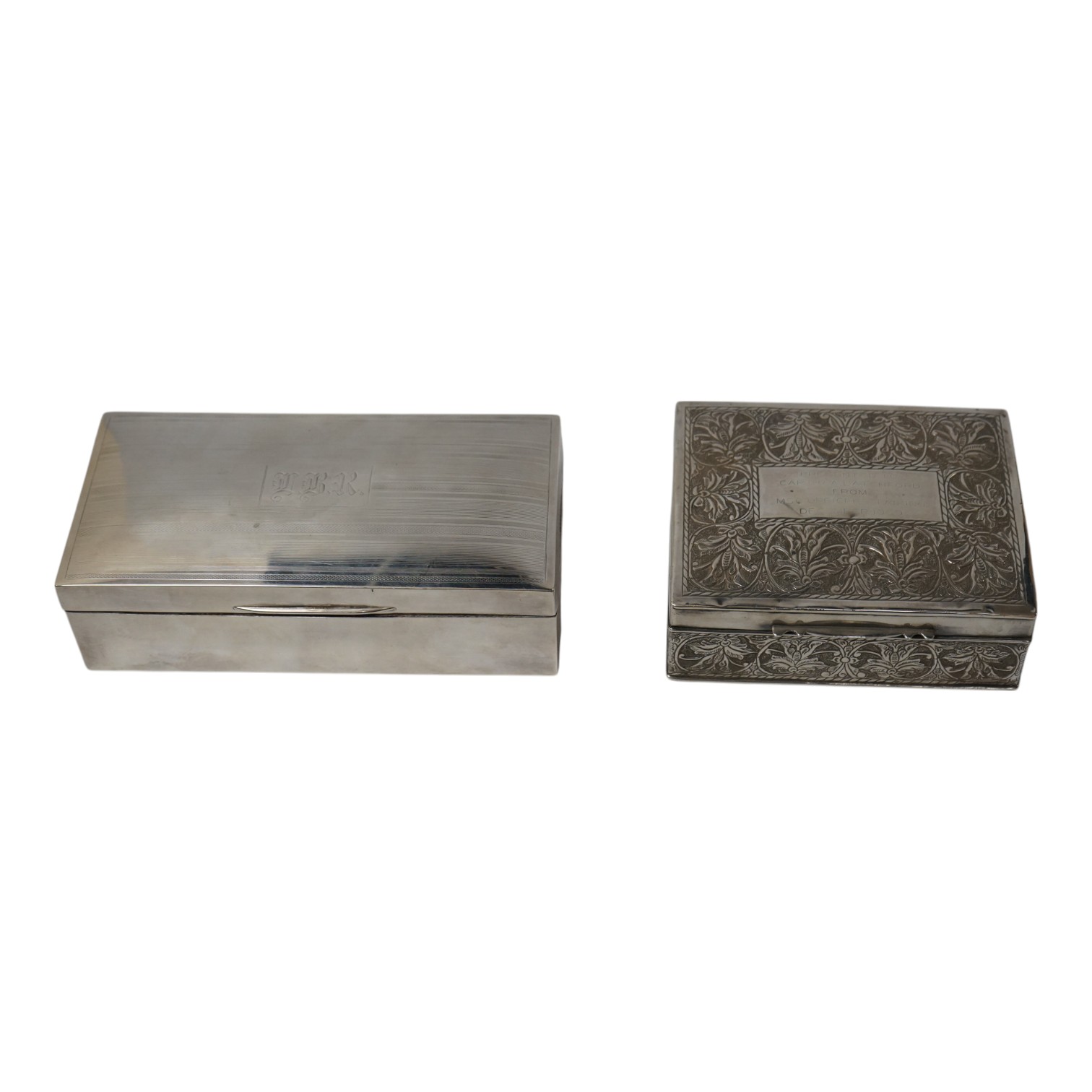 A George V silver mounted rectangular cigarette box, Birmingham, 1923, 17.9cm, together with a Thai white metal mounted cigarette box. Condition - fair